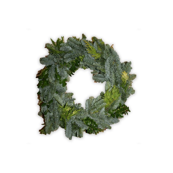 A lush green wreath made of pine and assorted foliage, inviting a fresh, natural vibe.