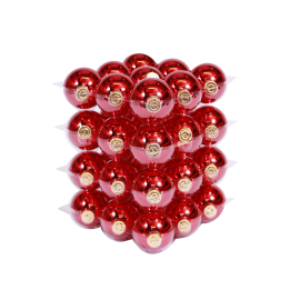 A stacked arrangement of shiny red ornaments with golden caps, reflecting light beautifully.