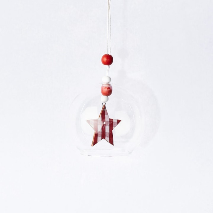 A clear glass ornament with a red and white striped star and colorful beads above.