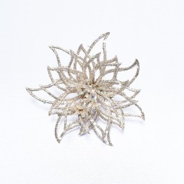 A delicate, shimmering silver flower brooch with intricate petal designs.