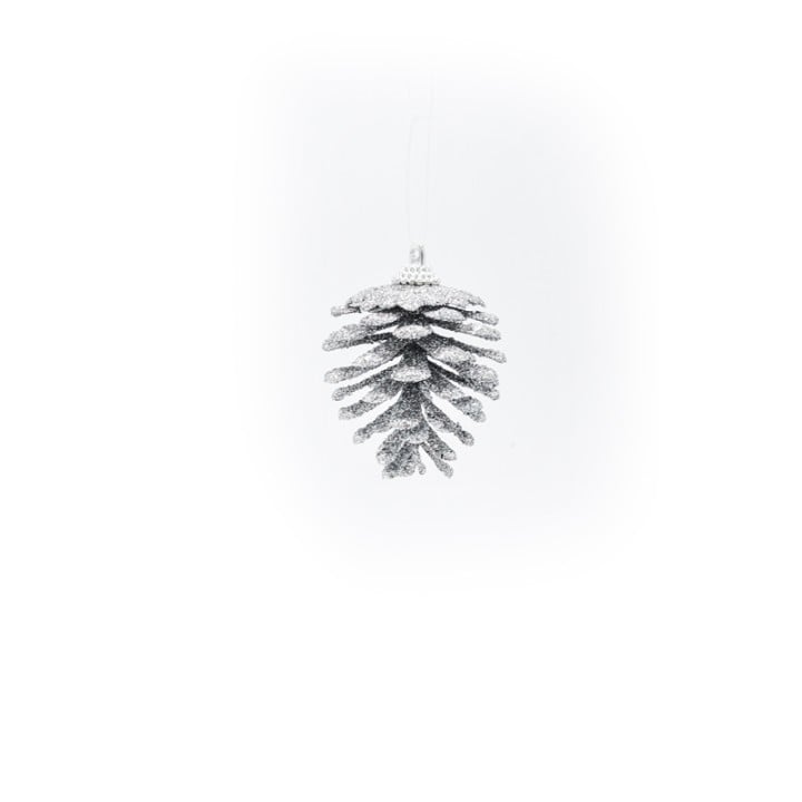 A shimmering white pinecone ornament hanging against a soft white background.