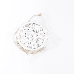 A circular white decoration with intricate star cutouts, packaged with twine.