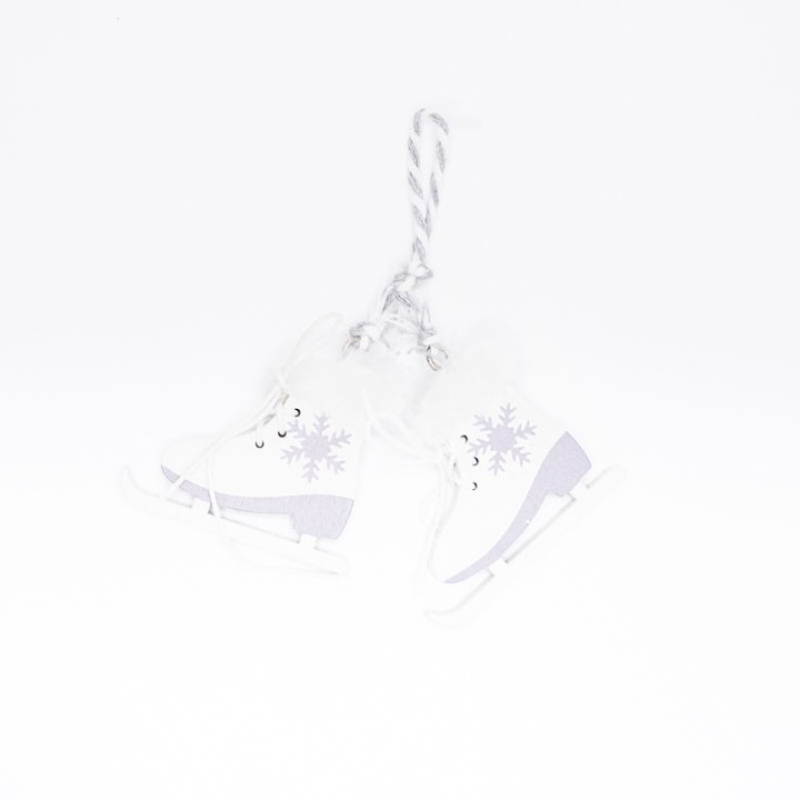 White ice skates with a silver and purple design, hanging by a twisted rope.