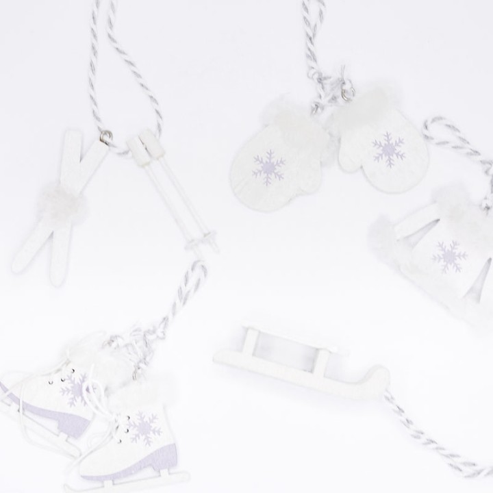Winter-themed ornaments featuring ice skates, mittens, and snowflakes in soft white and purple.