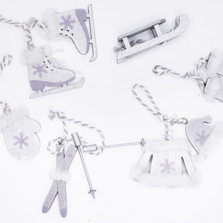 Wooden holiday ornaments in winter shapes, featuring skates, mittens, and a sled with white accents.