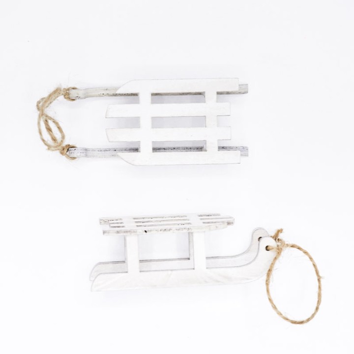 Two wooden sleighs in white, one larger and one smaller, with twine handles.