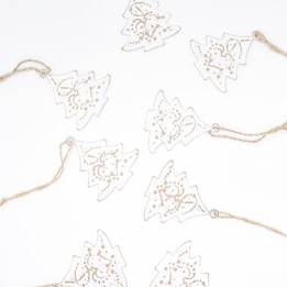 Delicate white paper Christmas trees adorned with golden outlines, strung on twine.