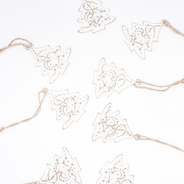 Delicate white paper Christmas trees adorned with golden outlines, strung on twine.