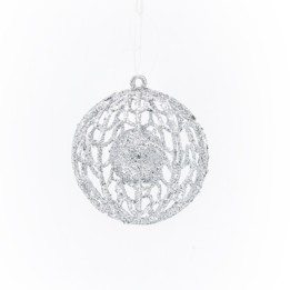A delicate, silver lace ornament with intricate cut-out patterns, shimmering against a white back...