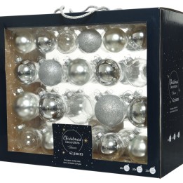 A box filled with silver and glittery Christmas ornaments in various shapes and sizes.