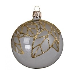 A round glass ornament in white with delicate gold leaf patterns.