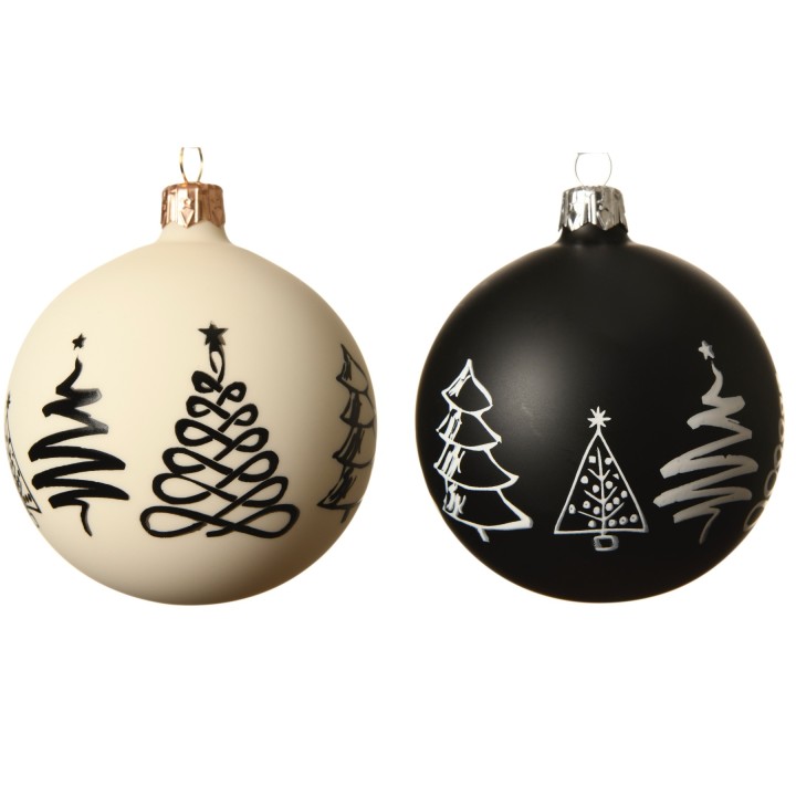 Two round Christmas ornaments, one cream with black designs, the other black with white trees.
