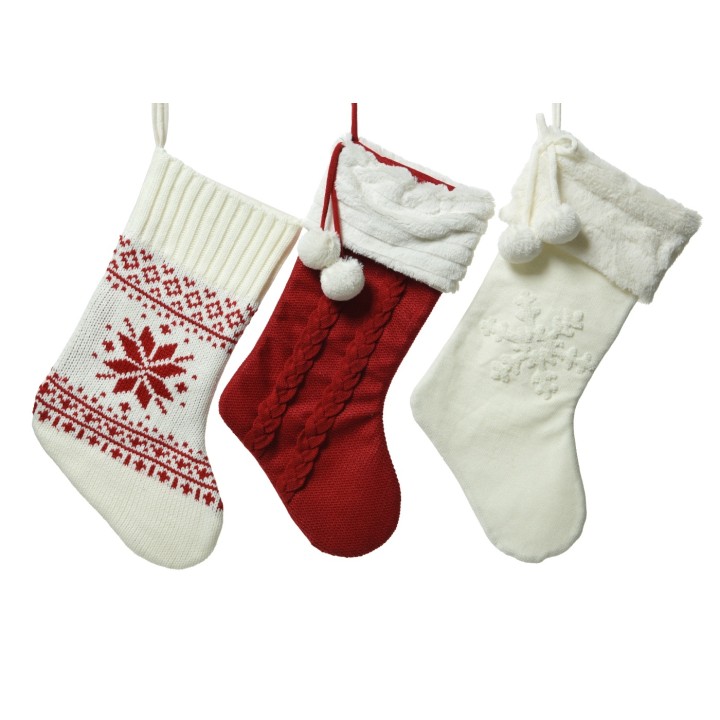 Three festive Christmas stockings in red, white, and cream, adorned with patterns and pom-poms.