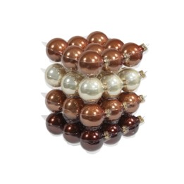 A stacked arrangement of shiny, decorative baubles in bronze, gold, and cream tones.