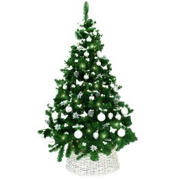 A lush green Christmas tree adorned with white ornaments and lights in a woven basket.