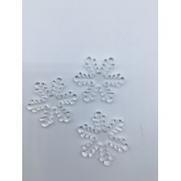 Three delicate, transparent snowflake shapes with intricate patterns on a white surface.