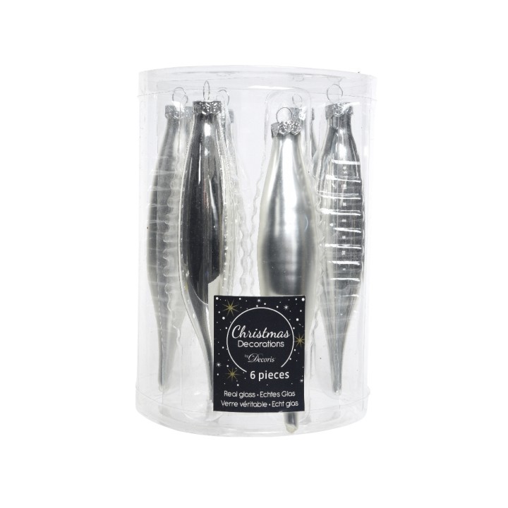 A clear cylindrical container holds six shiny silver Christmas ornaments in various shapes.