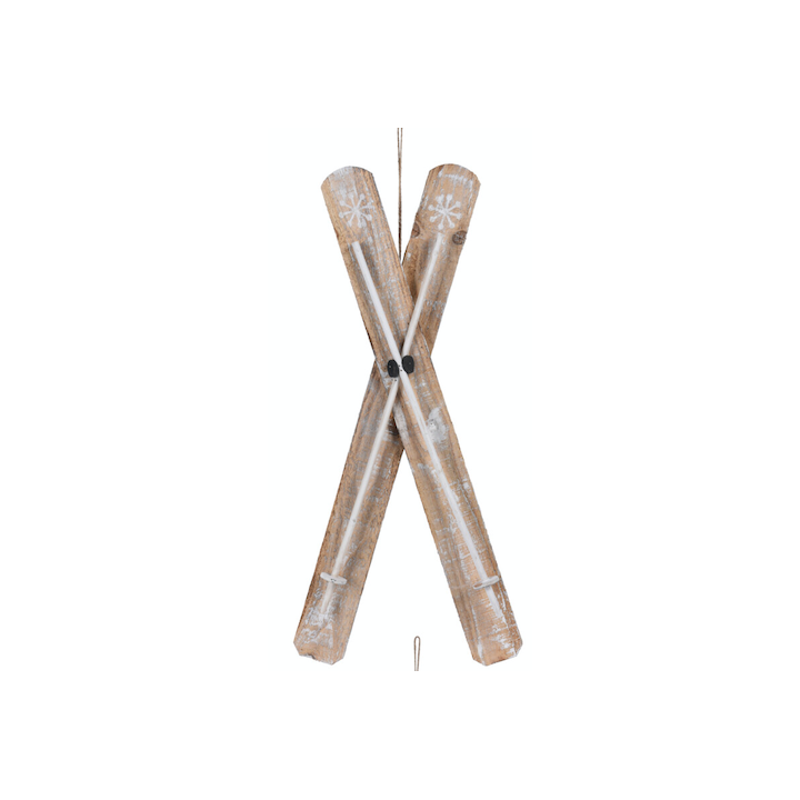 Two rustic wooden skis crossed, adorned with white snowflake patterns.