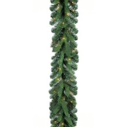 Groene kerstguirlande met takken en kleine sfeervolle lampjes.