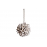 A textured, spherical decoration with layered, natural elements and a rustic twine hanger.