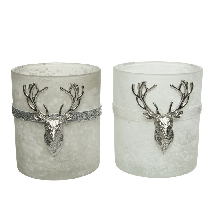 Two frosted candle holders, one gray and one white, adorned with silver deer head accents.