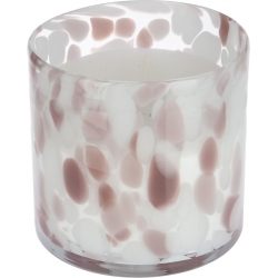 A round candle in a translucent glass holder with soft pink and white speckled patterns.
