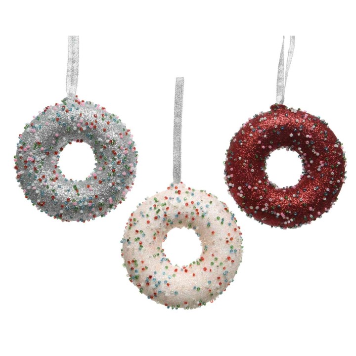 Three glittery donut ornaments in silver, white, and red with colorful sprinkles.