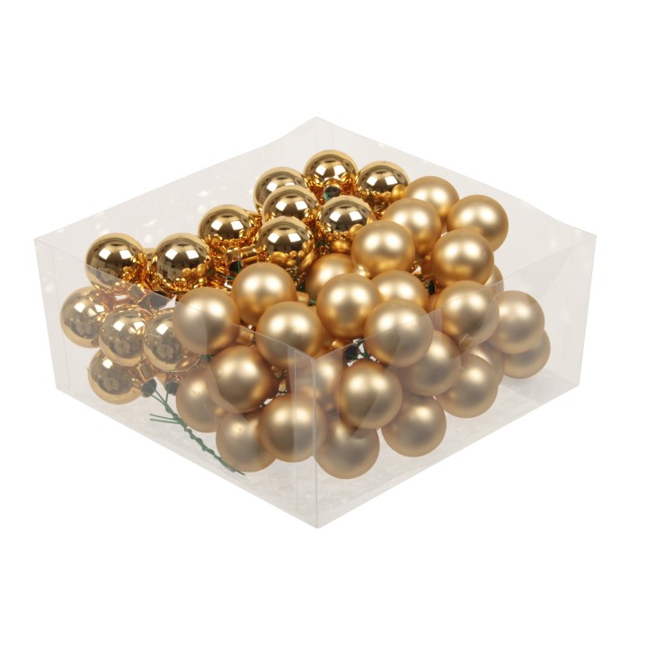 Gouden kerstballen in een doorzichtige doos, variërend in glans en matte afwerkingen.