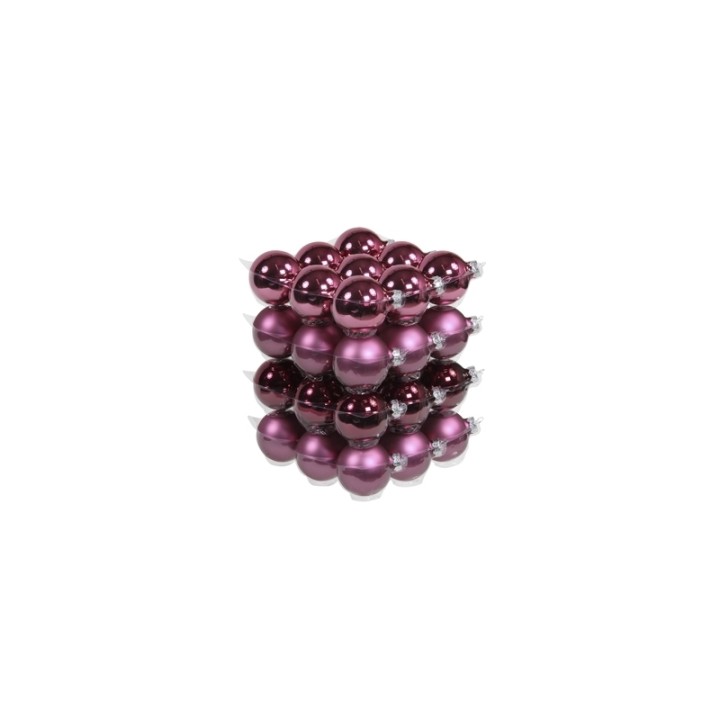 A stack of shiny purple Christmas ornaments reflecting light beautifully.