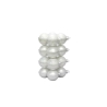 A stack of glossy white ornaments with a smooth, shiny surface.