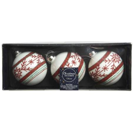 Drie witte kerstballen met rode en groene versieringen in een chique doos.