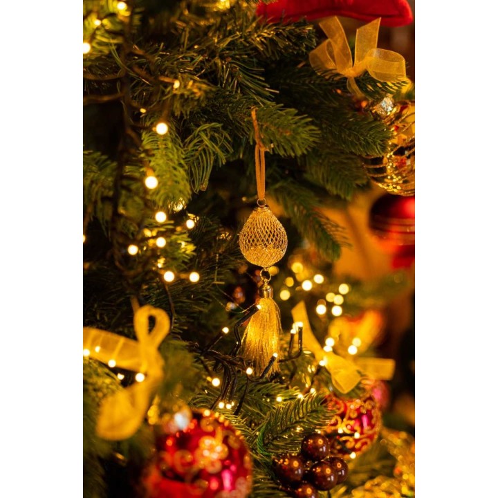 A beautifully decorated Christmas tree adorned with golden ornaments and warm lights.