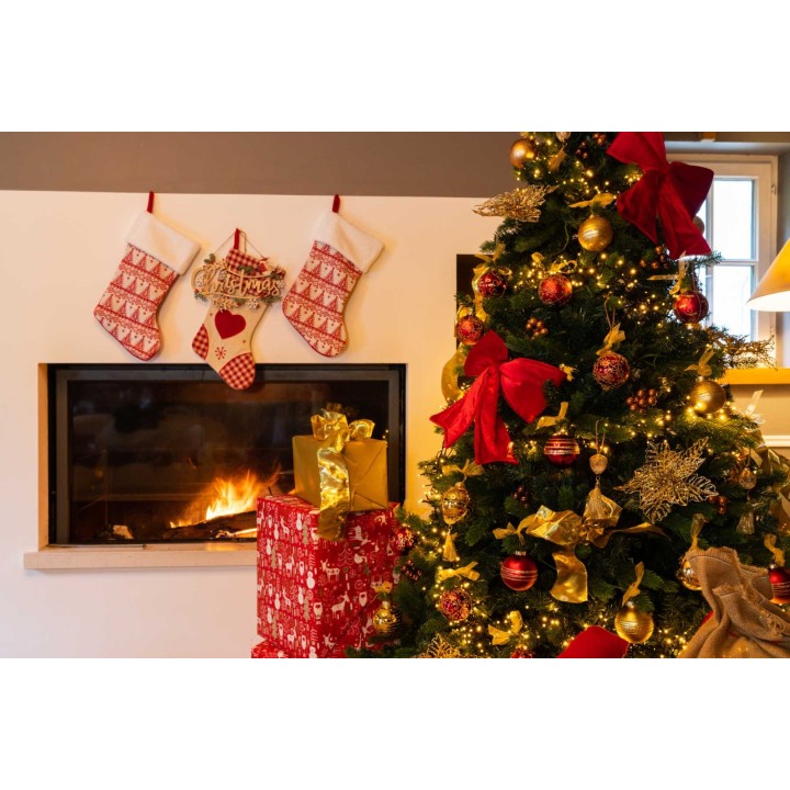 A cozy Christmas scene with a decorated tree, stockings, and a warm fireplace glow.