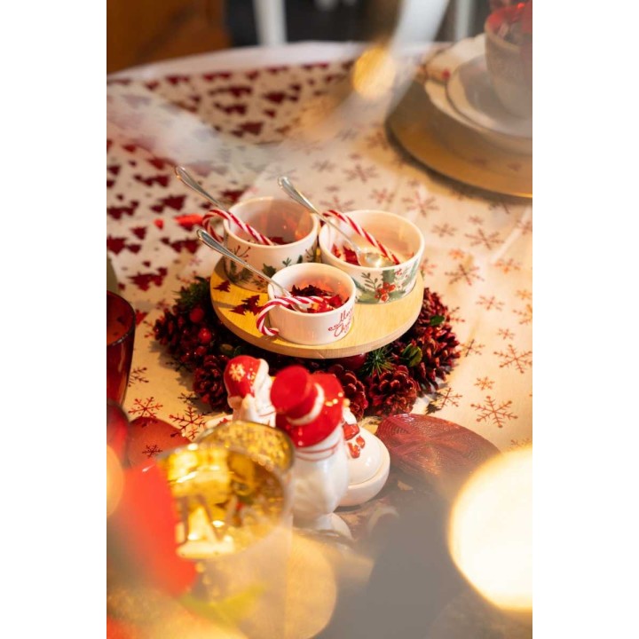 A festive table setting with bowls of treats, surrounded by holiday decorations and snowmen.
