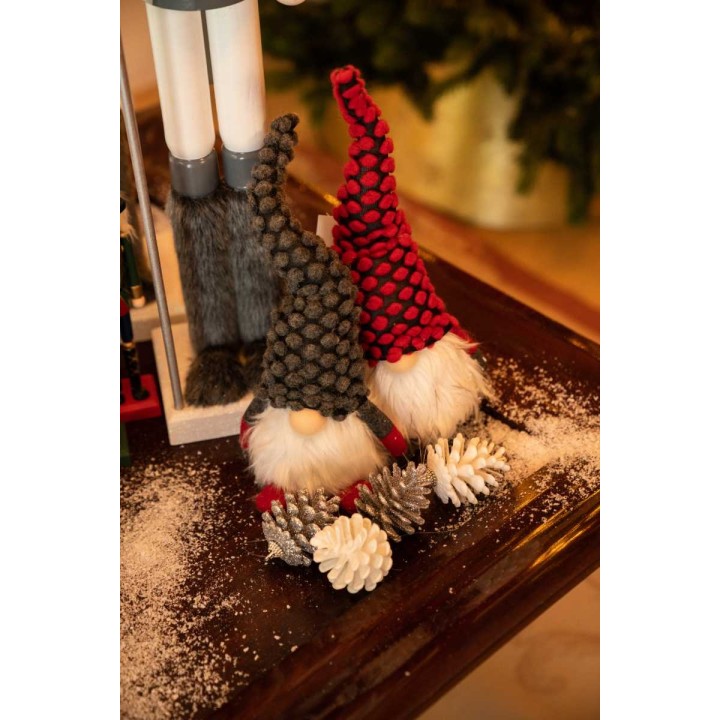 Two whimsical gnomes with fuzzy beards and colorful hats, surrounded by pinecones and snow.