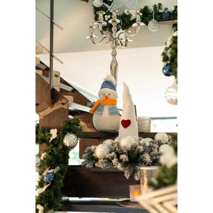 A cozy winter scene featuring a snowy penguin and a white cone-shaped decoration with a heart.