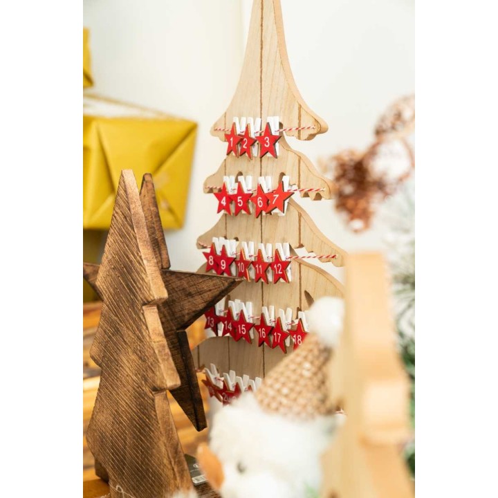 A wooden Christmas tree advent calendar with red numbered doors, beside a rustic star.