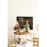 A cozy living room scene with a warm fireplace, festive decorations, and a stylish coffee table.