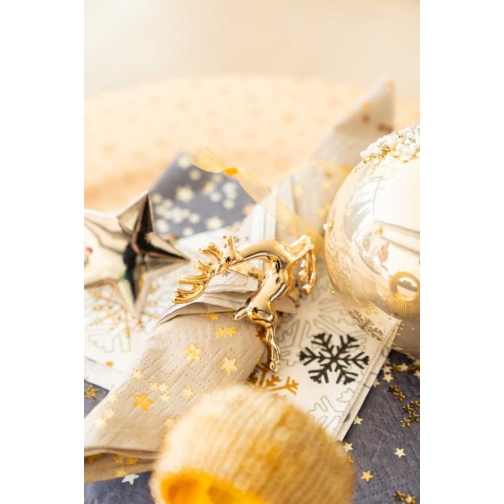 A festive arrangement with gold accents, shimmering ornaments, and patterned fabric.