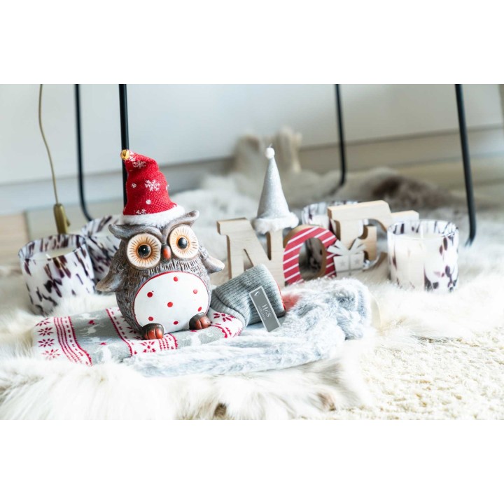 A cozy holiday scene with a festive owl, soft textures, and cheerful decor elements.