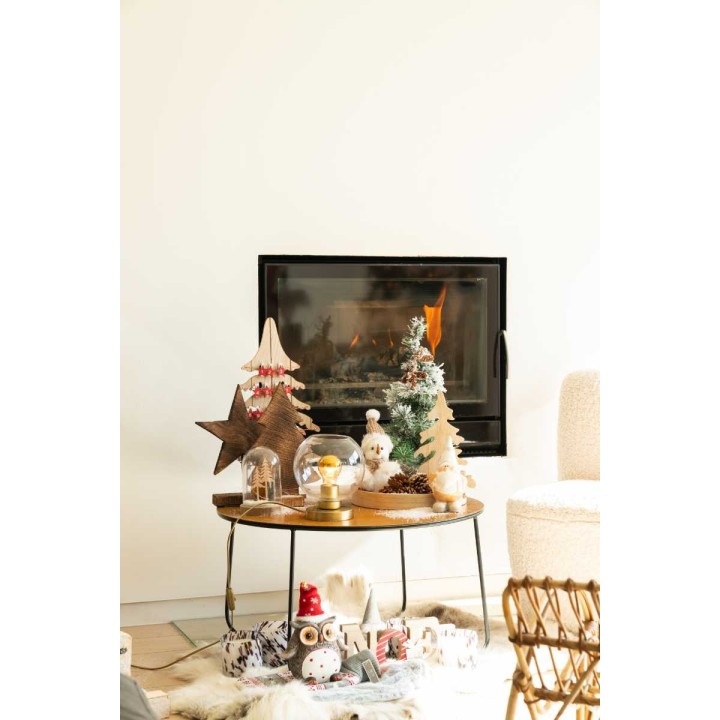 A cozy scene with a fireplace, decorated tabletop, and festive trees in soft colors.