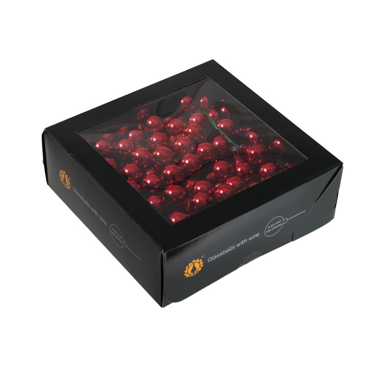 A black box with a transparent lid filled with shiny red candies.