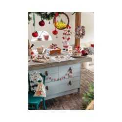 A cozy kitchen adorned with festive decorations, featuring a charming wooden countertop and color...