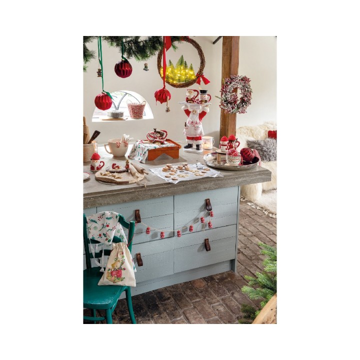 A cozy kitchen adorned with festive decorations, featuring a charming wooden countertop and color...