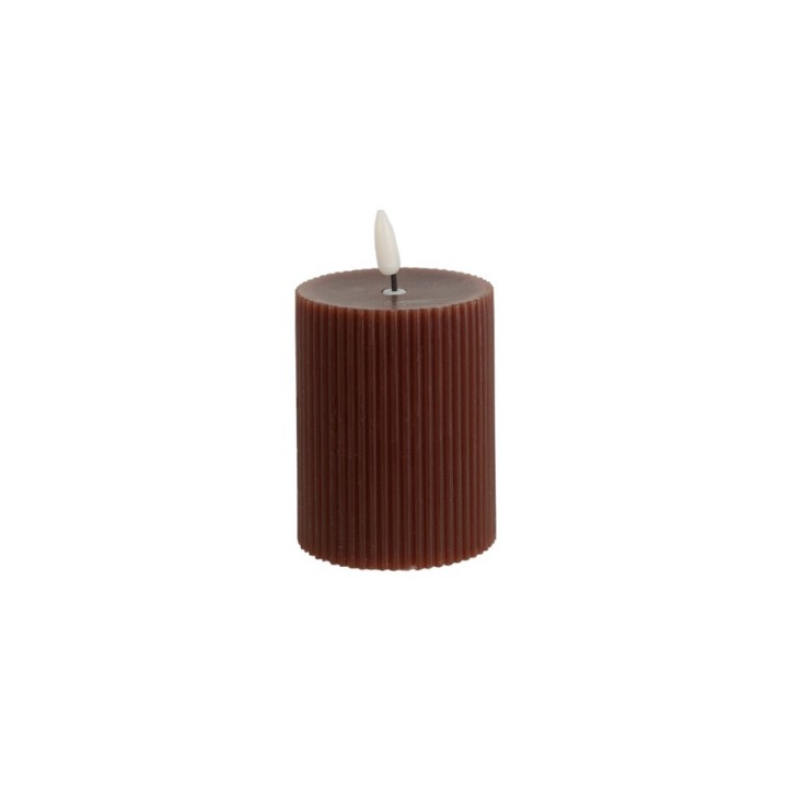 A cylindrical, ribbed brown candle with a small white wick on top.