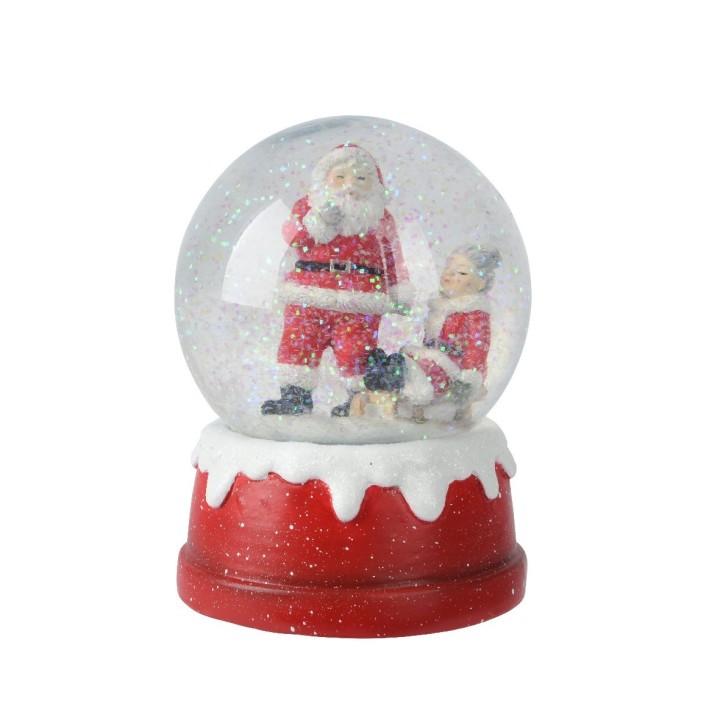 Boule à neige festive avec un Père Noël et une fillette, sur base rouge et blanche.