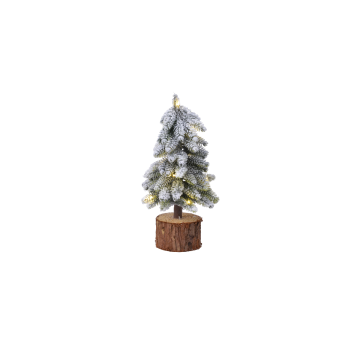 A small, snowy Christmas tree with warm lights on a wooden base.