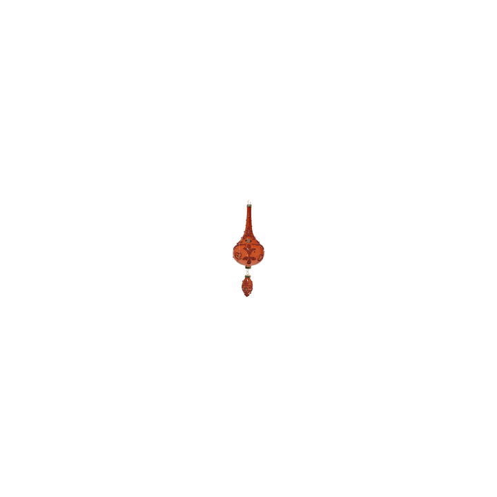 A vibrant red decorative ornament with intricate floral patterns and elegant shapes.