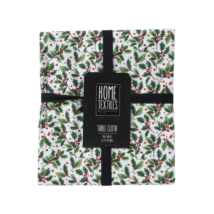 A folded tablecloth with a white background adorned with green leaves and red berries.