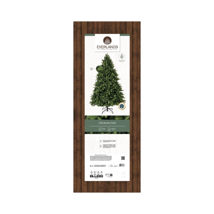 Een groene kunstkerstboom met een houten achtergrond en bijbehorende informatie.